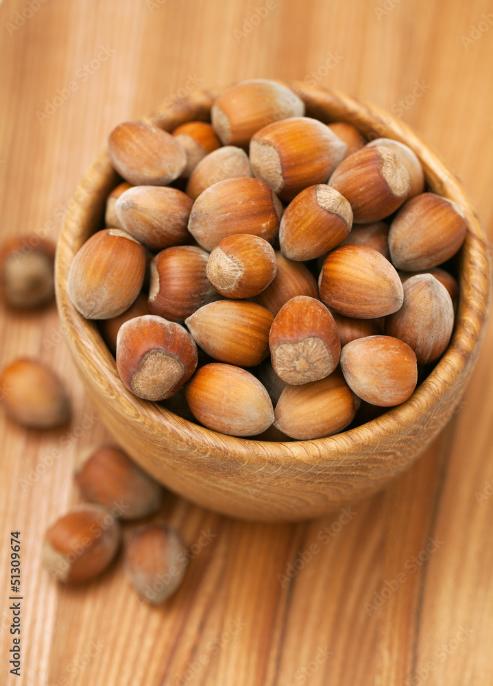 hazelnuts in a wooden bowl hazelnuts in a wooden bowl