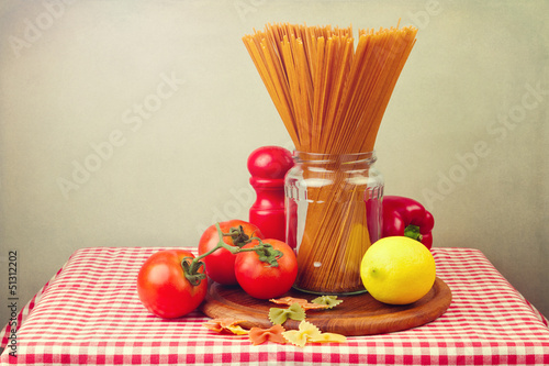 Whole wheat spaghetti and vegetables on red tablecloth