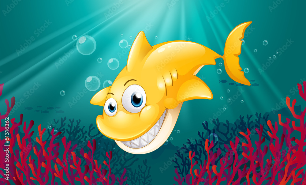 Obraz premium A yellow shark smiling under the sea