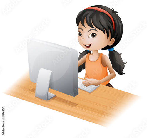 A young girl using the computer