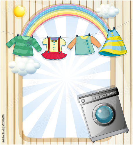 A washing machine with hanging clothes at the top