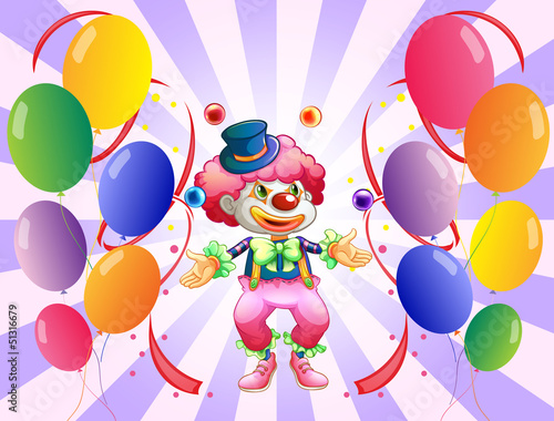 A clown juggling in the middle of the balloons