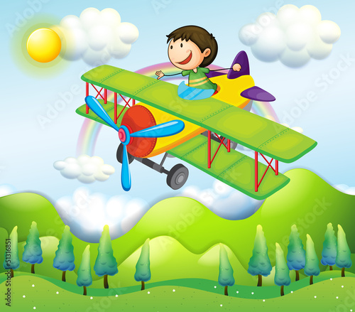 A young man riding in a colorful plane