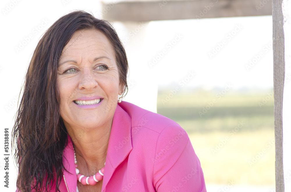 Confident happy mature woman in pink