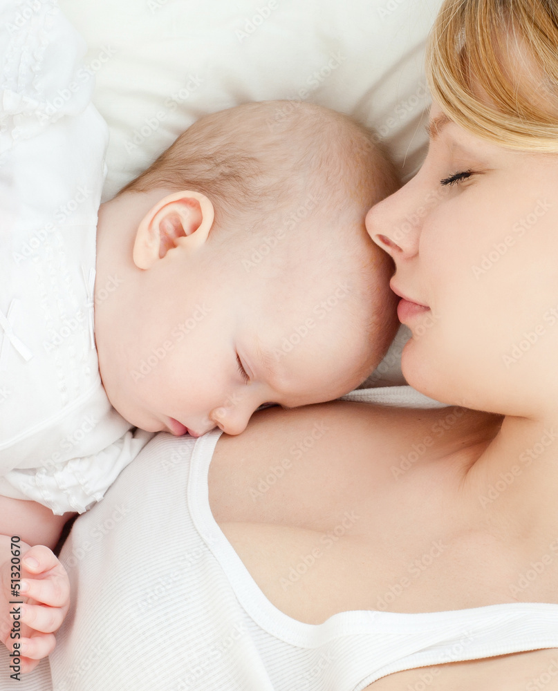 Young mother and her baby, sleeping in bed Young mother and her baby, sleeping in bed