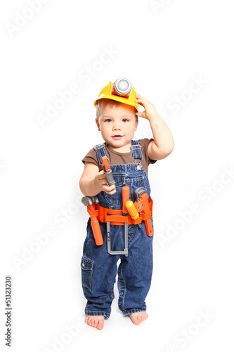 Cute little boy in an orange helmet and tools on a white backgro