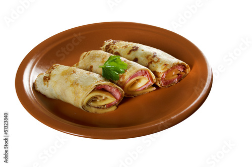 rolled pancakes stuffed ham and cheese. photo