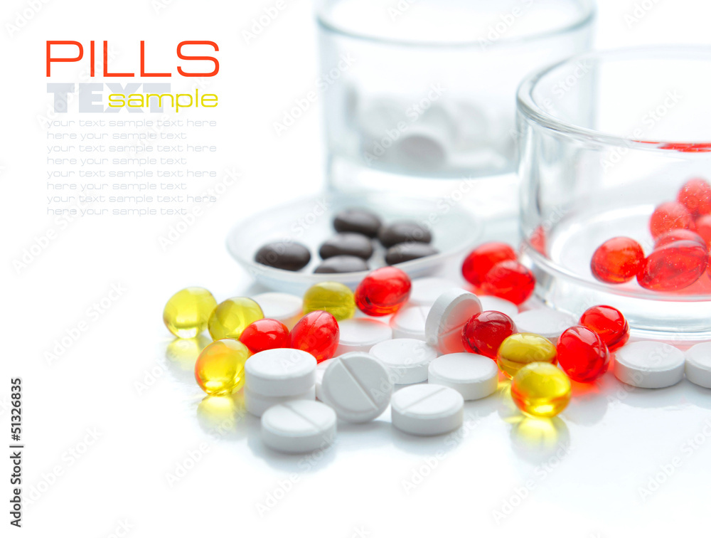 Red capsules are in a spoon on a background the color capsules Red capsules are in a spoon on a background the color capsules