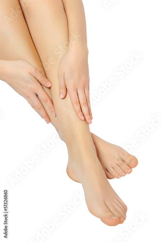 Fototapeta Naklejka Na Ścianę i Meble -  Beautiful female feet with hands on them isolated on white