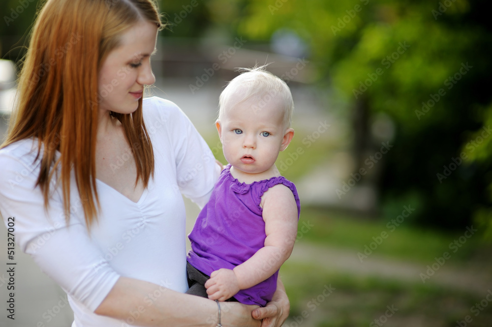 Eight months old baby in mothers hands Eight months old baby in mothers hands