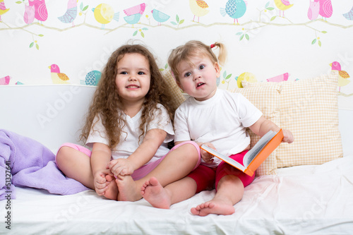 kids sisters reading a book...
