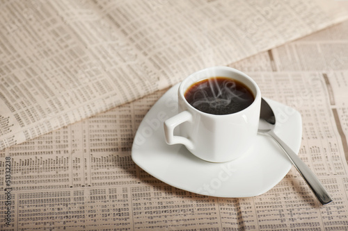 coffee cup on newspapers