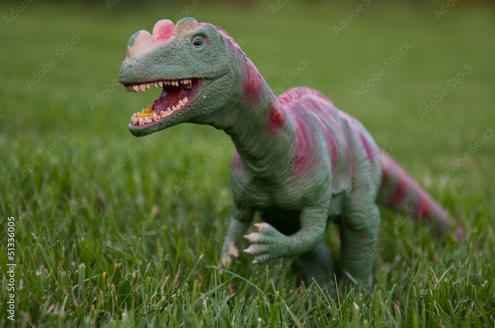 dinosaur toy on grass