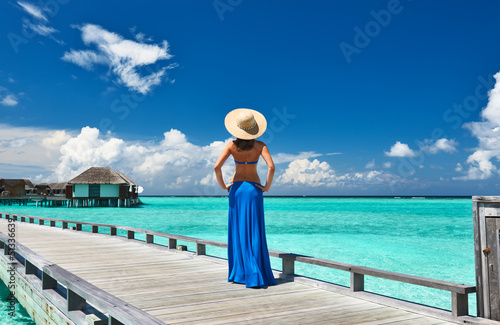 Woman on a beach jetty at Maldives