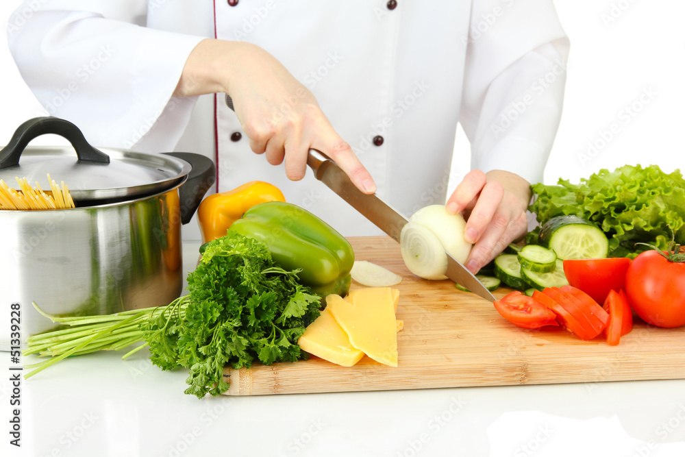 Female hands cutting vegetables, isolated on white
