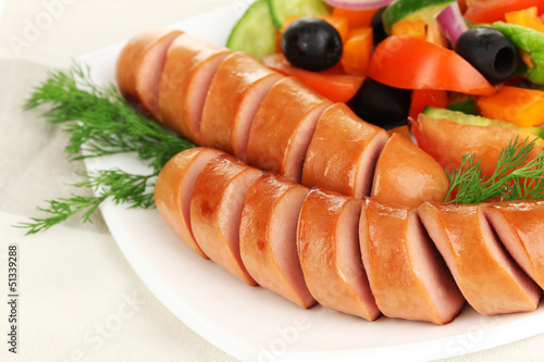 Grilled sausage with fresh salad close up