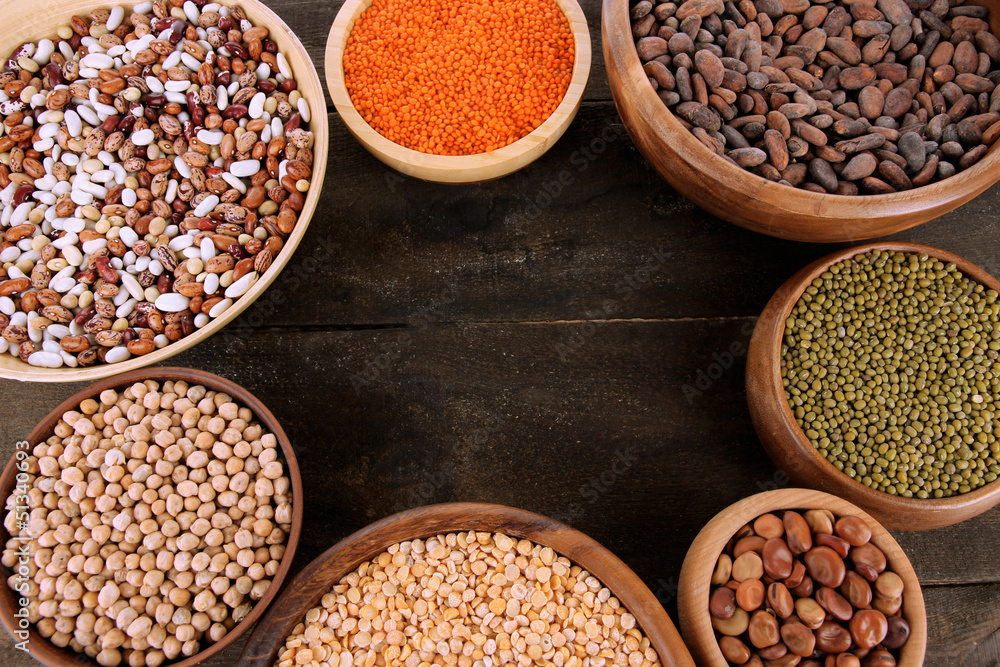 Different kinds of beans in bowls on table close-up Different kinds of beans in bowls on table close-up