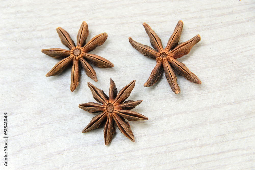 Anise spice over a white wooden background