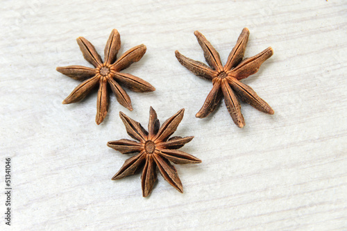 Anise spice over a white wooden background