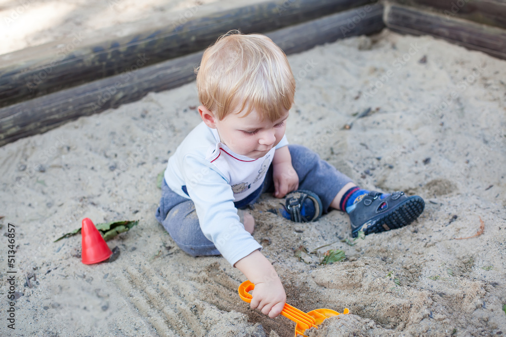 Little toddler boy playing with sand and toy Little toddler boy playing with sand and toy