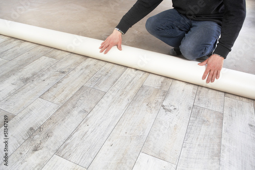 rolling out a PVC flooring photo