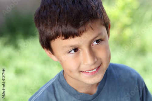 Smiling young boy outside with copy space