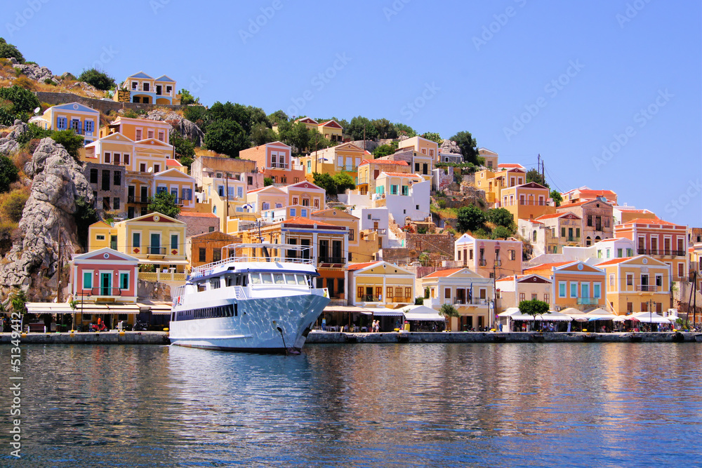 Colorful houses lining the harbor at Symi, Greece