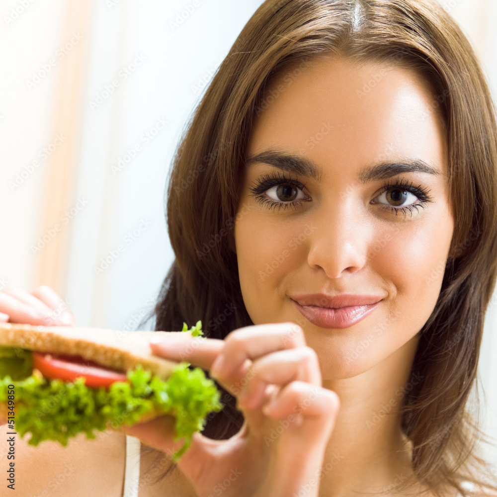 Happy smiling woman with sandwich at home Happy smiling woman with sandwich at home