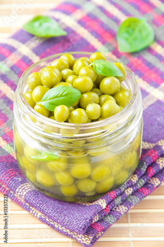 Tinned green peas in glass jar