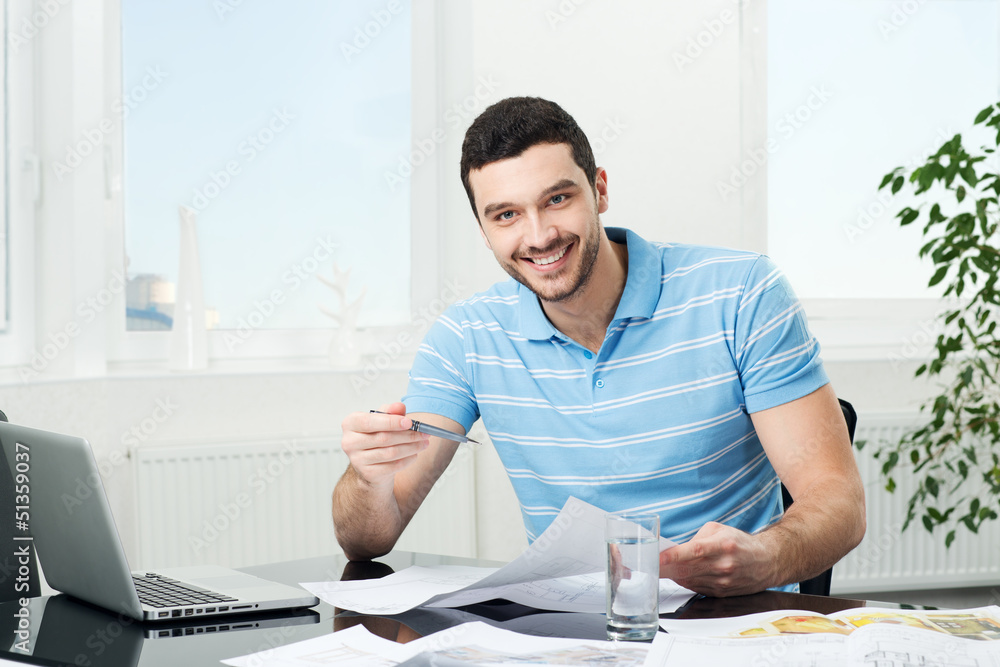 handsome young interior designer at workplace handsome young interior designer at workplace