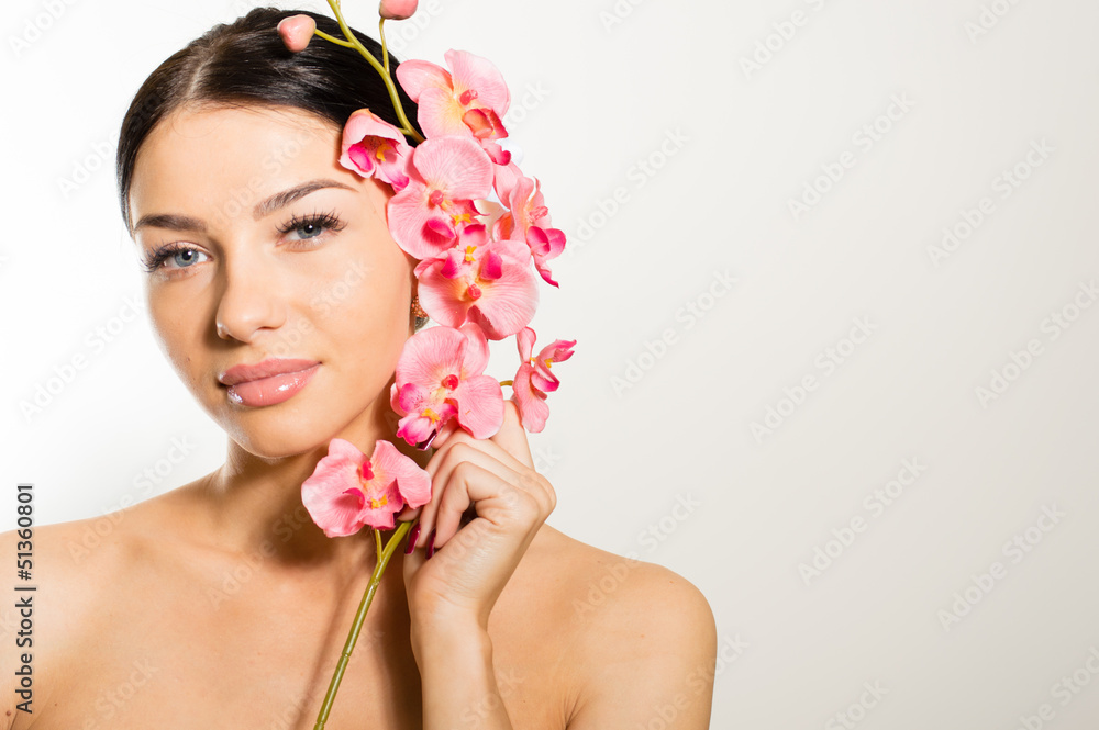 Beautiful girl holding pink flowers with perfect skin, lips. Beautiful girl holding pink flowers with perfect skin, lips.