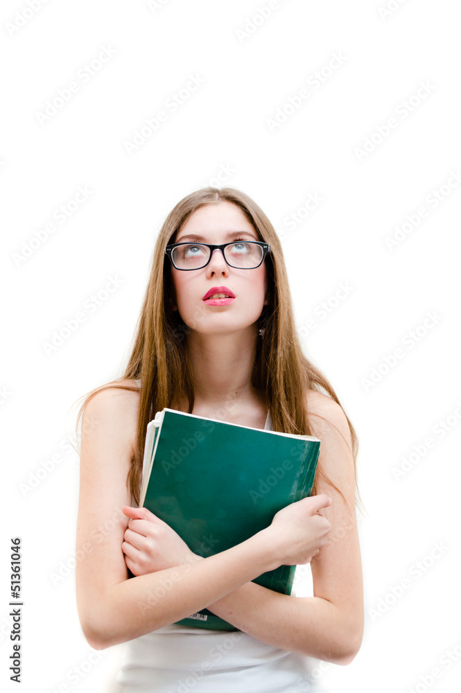 Teenage girl in glasses holding book and looking up