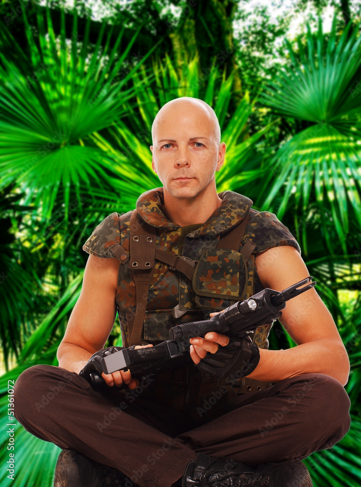 Armed soldier is sitting in jungles