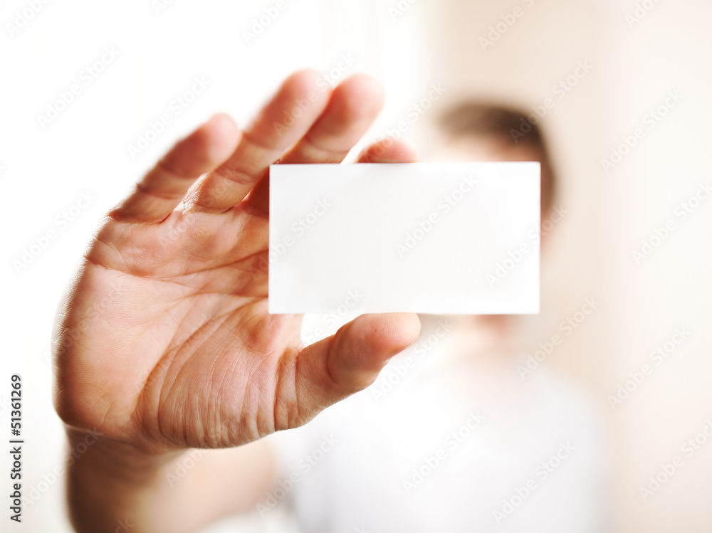 Human hand holding blank business card with copy space, small do Human hand holding blank business card with copy space, small do