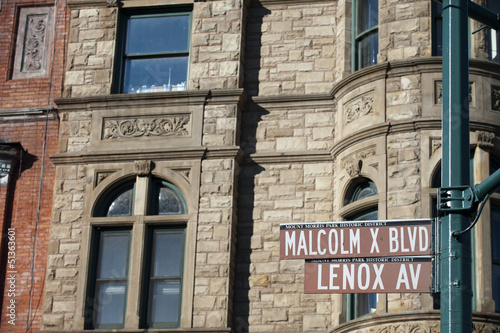 Malcom X and Lenox Avenue sign in Harlem, new York photo