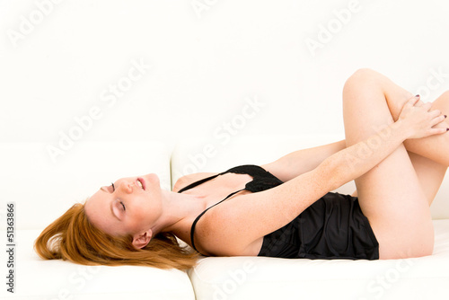 woman in lingerie relaxing on a sofa