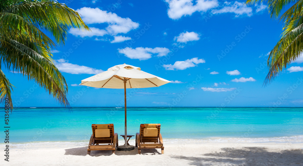 two deckchairs on the idyllic white beach turquoise sea