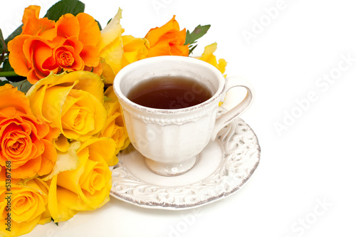 orange rose and white cup