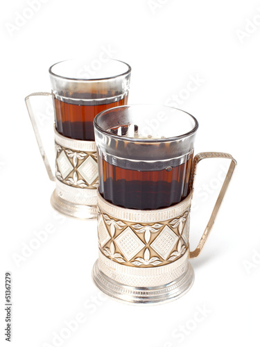 glass of black tea with glass holder isolated on white backgroun
