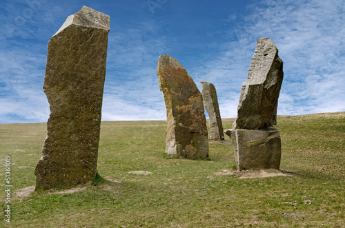 Standing stones against blue sky photo