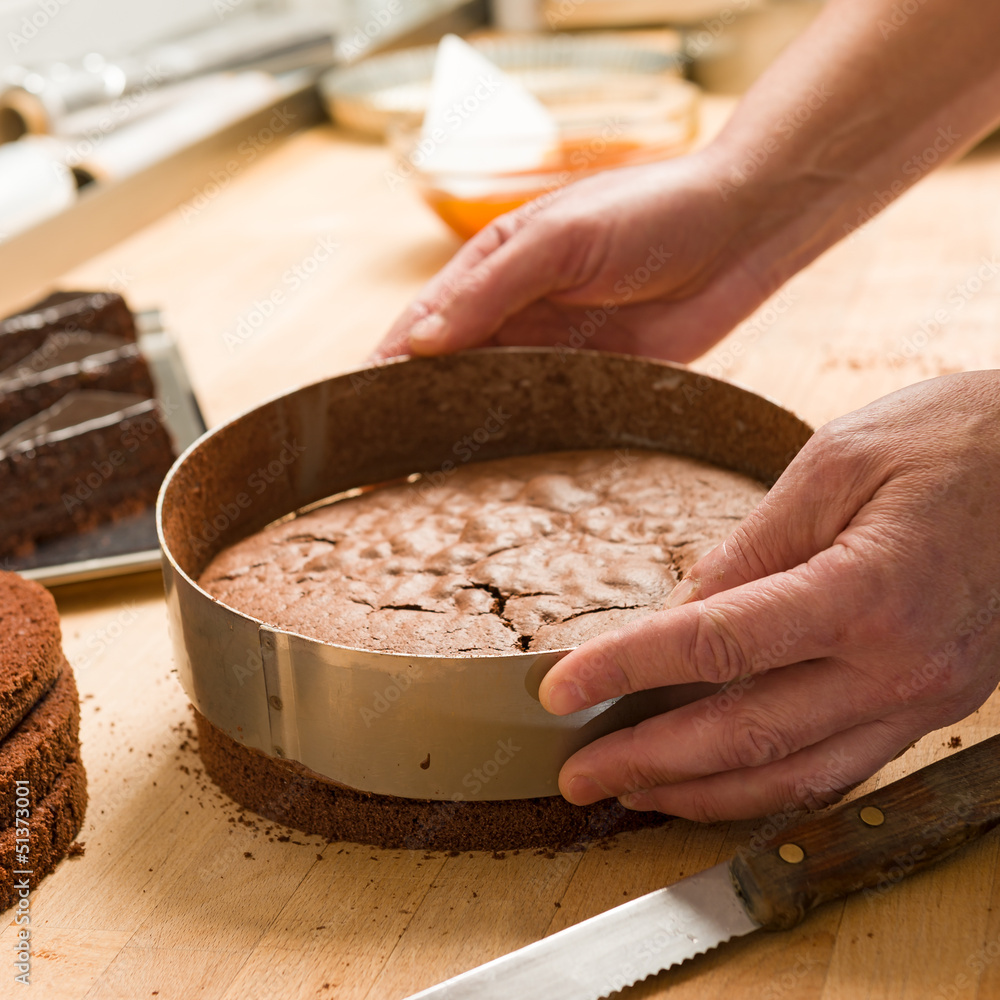 Fototapeta premium Cook taking out cake from cake form
