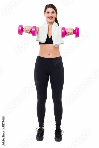 Fitness trainer holding dumbbells, arms outstretched