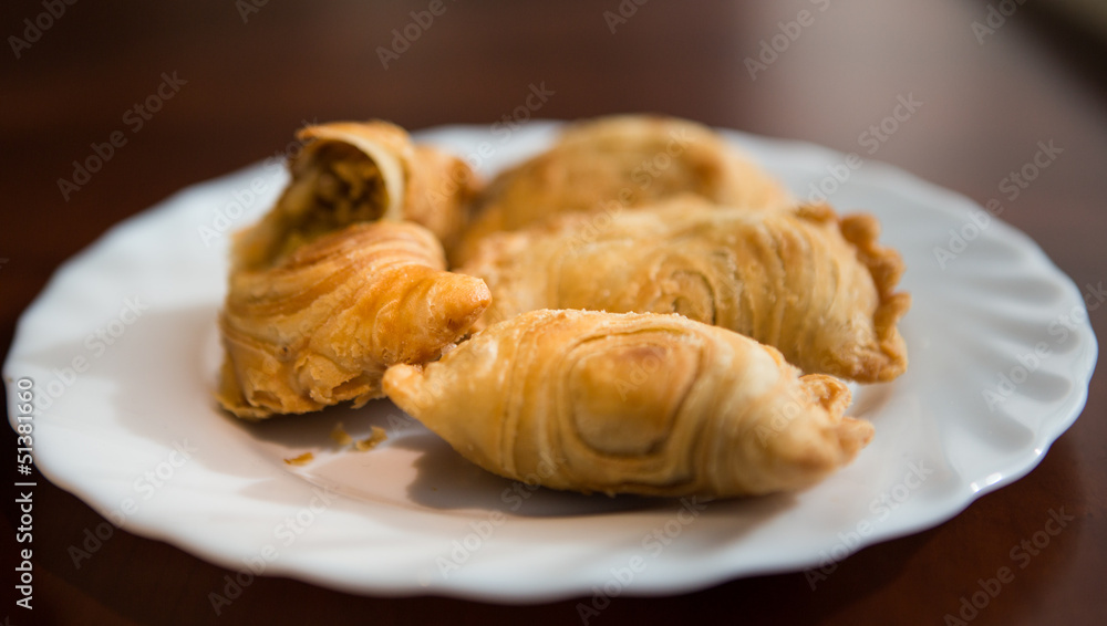 Malaysian favourite snack, curry puff on a white plate Malaysian favourite snack, curry puff on a white plate