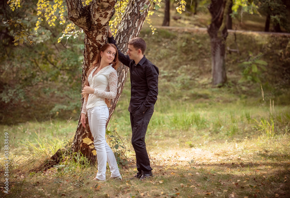 Love and affection between a young couple at the park Love and affection between a young couple at the park