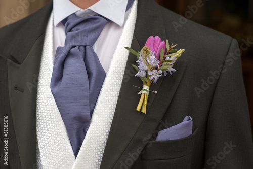 groom with purple flower buttonhole