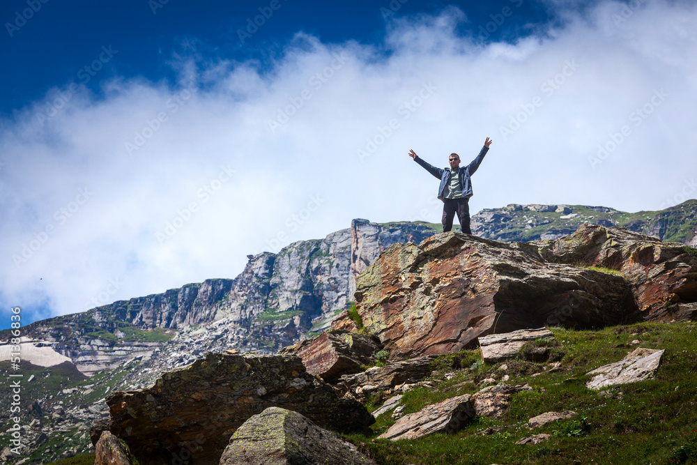 Happy tourist in mountains