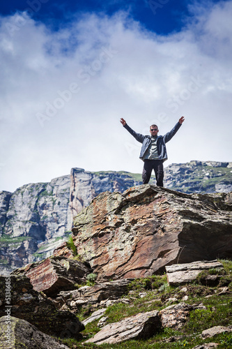 Happy tourist in mountains