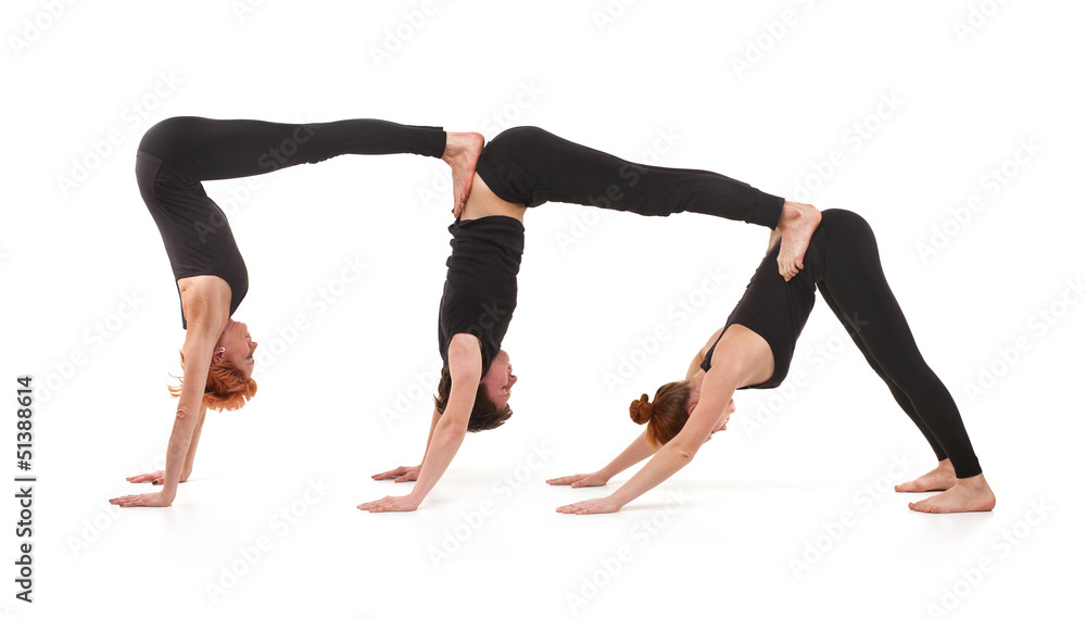 Two women and one men practicing yoga Two women and one men practicing yoga