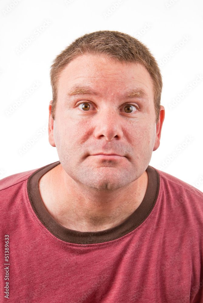 A clean shaven Caucasian leaning forward making a funny face A clean shaven Caucasian leaning forward making a funny face