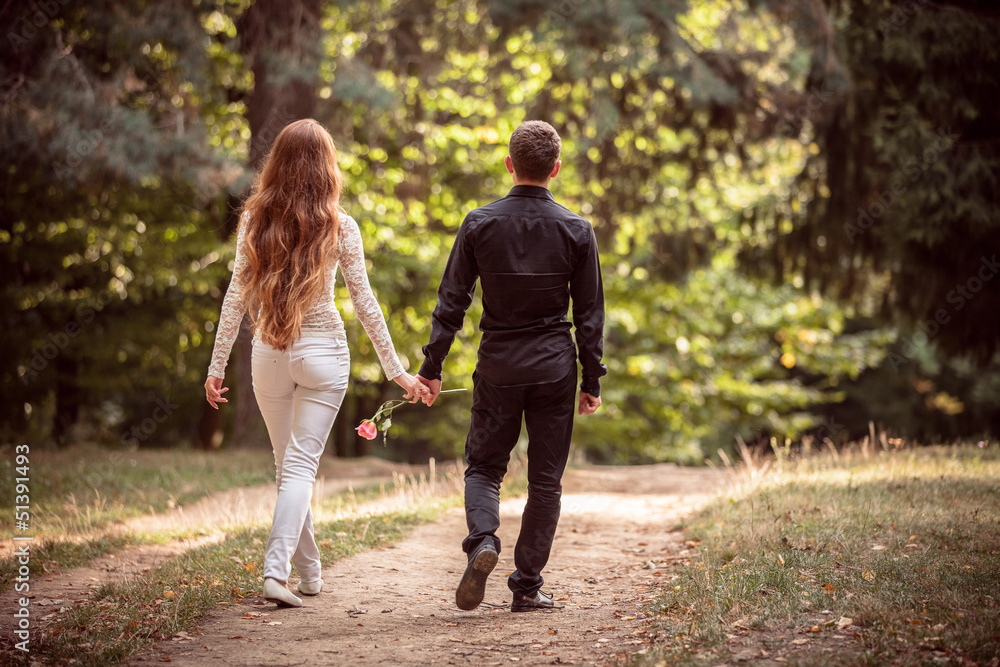 Love and affection between a young couple at the park Love and affection between a young couple at the park
